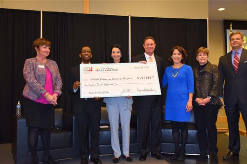 Oversized $200,000 check held by local school superintendents to share for NBCT training 